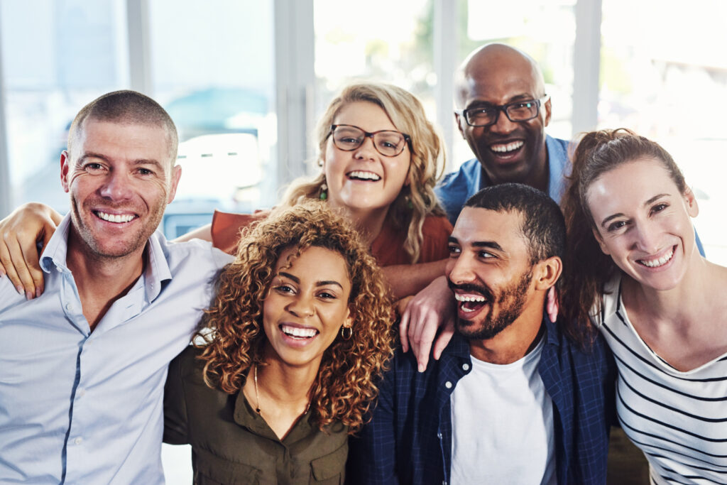 Businesspeople smiling and happily working together.